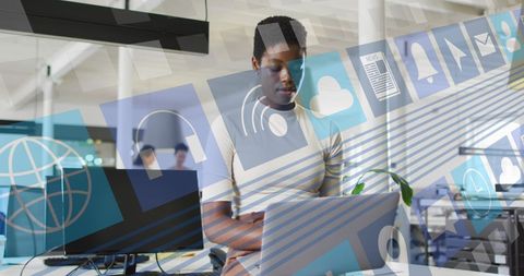 African American Businesswoman Using Laptop with Digital Overlay
