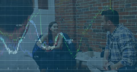 Multicultural Business Team Analyzing Financial Graphs Together