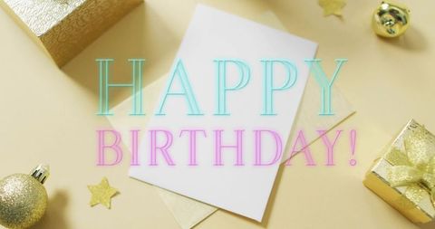 Happy Birthday Greeting Card on Pastel Flatlay with Gold Gifts and Confetti