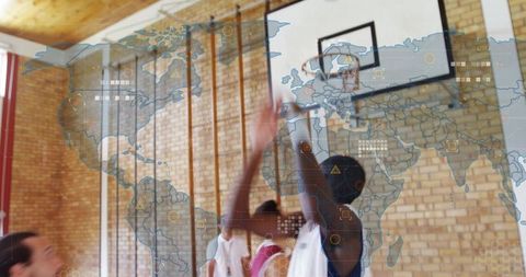 Jumping basketball player reaching for hoop in gym with world map data overlay