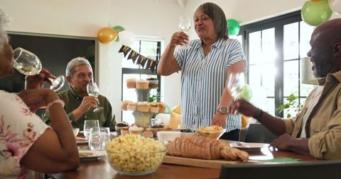 Senior Friends Toasting Retirement Celebration at Home with Joy