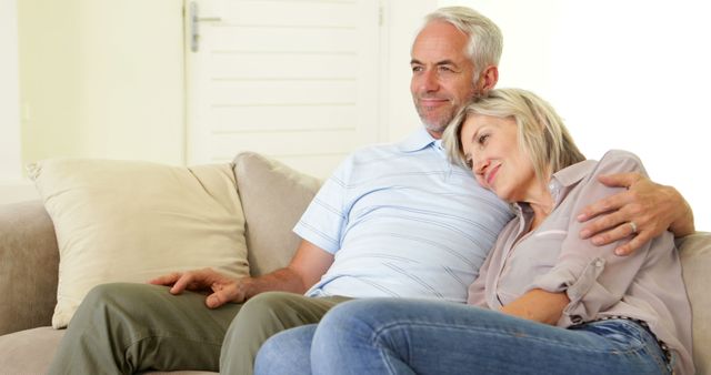 Happy Senior Couple Relaxing on Couch Together - Download Free Stock Images Pikwizard.com