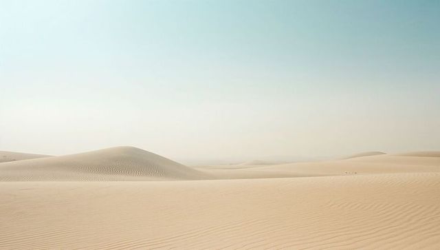 Wind-Swept Sand Dunes Under Clear Blue Sky