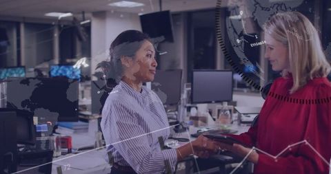 Businesswomen collaborating in modern corporate office setting