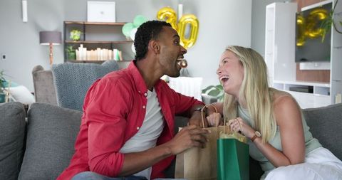 Happy Couple Celebrating Birthday with Gifts at Home