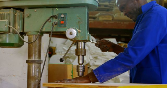 African American Craftsman Operating Industrial Drill Machine in Workshop - Download Free Stock Images Pikwizard.com