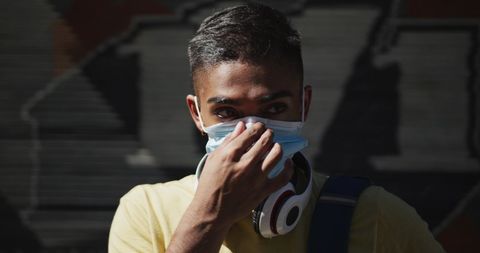 Man Adjusting Face Mask Outdoors During Pandemic - Download Free Stock Images Pikwizard.com