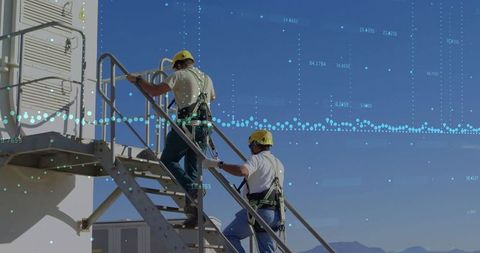 Industrial workers climbing metal stairs ensuring safety on-site