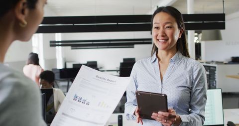 Confident Businesswoman Discussing Quarterly Report in Modern Office - Download Free Stock Images Pikwizard.com