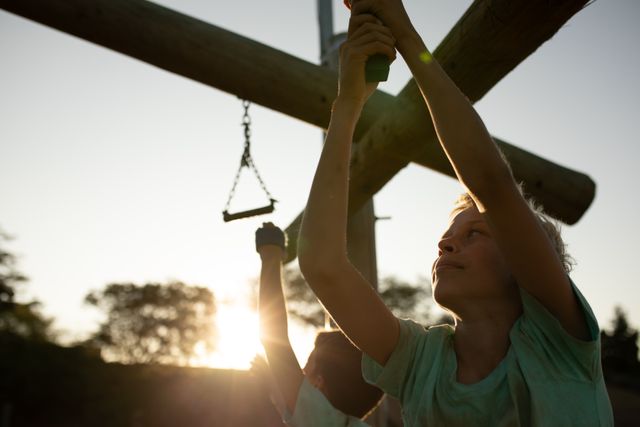 Smiling Boy Hanging from Jungle Gym at Boot Camp - Download Free Stock Images Pikwizard.com