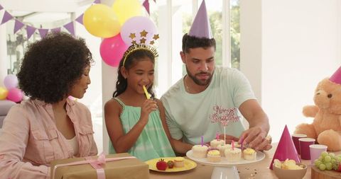 Family Celebrating Home Birthday with Cupcakes and Fun