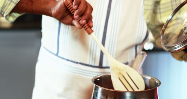 Chef Stirring Pot with Wooden Spoon in Kitchen - Download Free Stock Images Pikwizard.com