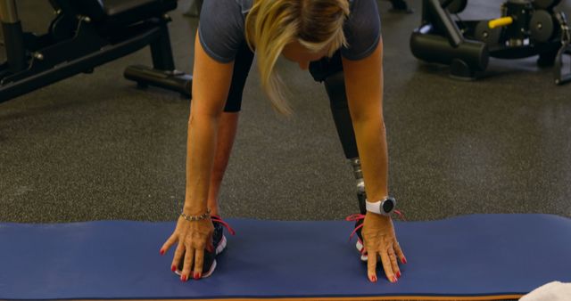 Woman with Prosthetic Leg Performing Yoga in Gym - Download Free Stock Images Pikwizard.com