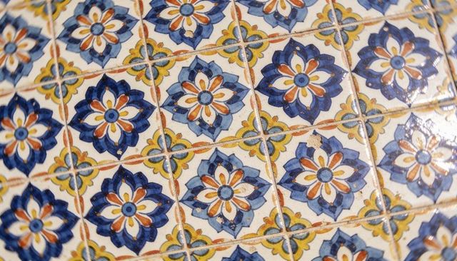 Showing vintage blue floral ceramic tiles with glossy glaze and small chips