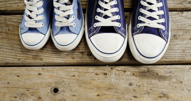 Close-up of Father and Child Sneakers on Wooden Surface - Download Free Stock Images Pikwizard.com