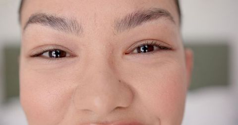 Close-Up of Calm and Approachable Young Woman with Freckles