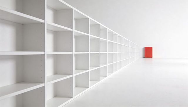 Endless white modular shelving creating dramatic perspective with single red box accent