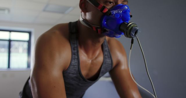 Man Wearing Mask Exercising on Stationary Bike for Fitness Test - Download Free Stock Images Pikwizard.com