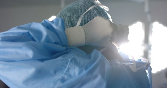 Surgeon wearing face mask and medical gloves in operating room. Medicine, healthcare, surgery and hospital, unaltered.