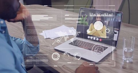 Man viewing remote colleague on laptop while ar analytics dashboards overlaying boardroom