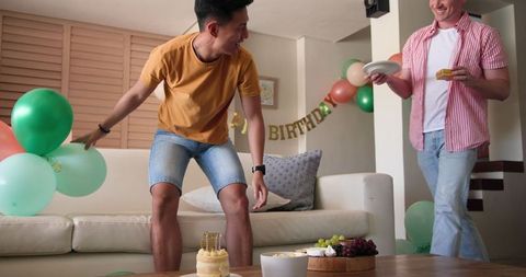 Friends Preparing Living Room for a Fun Birthday Celebration