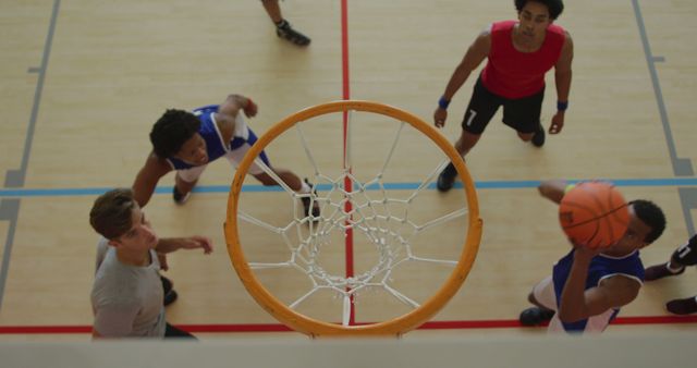 Overhead view of african american male basketball player scoring goal against diverse players - Download Free Stock Photos Pikwizard.com