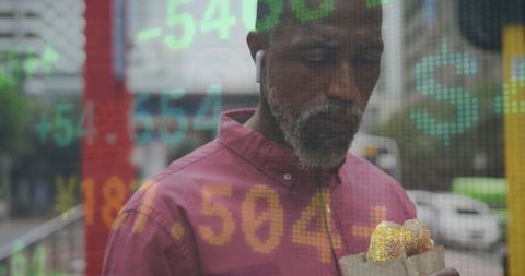 Businessman Evaluating Financial Data with Stock Market Overlay