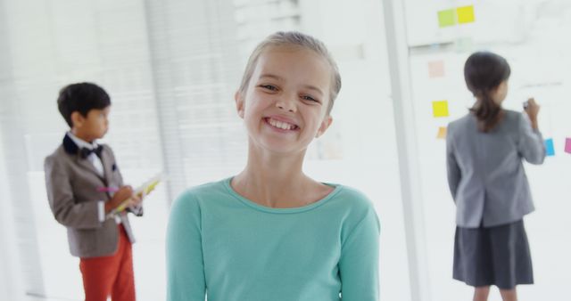 Smiling Child in Classroom with Peers in Background - Download Free Stock Images Pikwizard.com