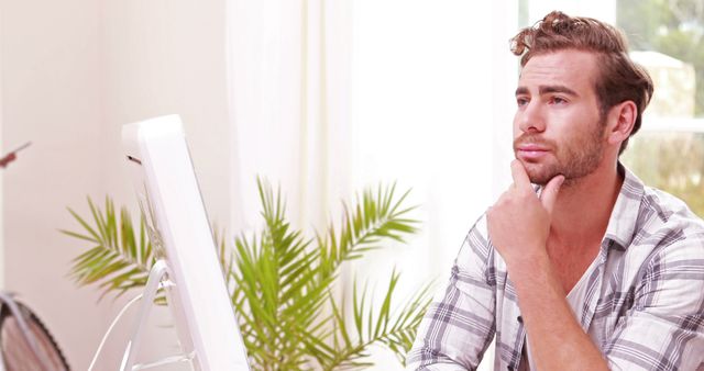 Contemplative Man Working on His Computer in Bright Office - Download Free Stock Images Pikwizard.com