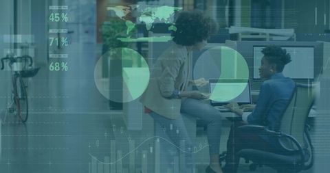 Businesswomen Analyzing Data on Digital Interface in Modern Office Environment