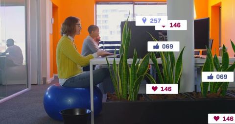 Woman working at vibrant office desk on blue exercise ball