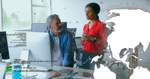 Colleagues discussing project in open-plan office with digital world map overlay