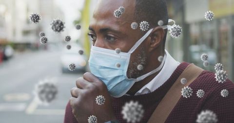 African american man coughing with covid-19 particles in urban background