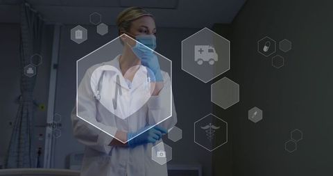 Clinician adjusting mask while interacting with digital healthcare interface in hospital room