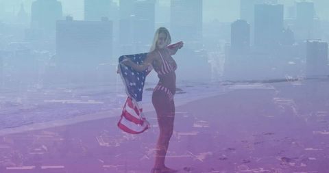 Woman standing on beach holding american flag and wearing flag bikini with city skyline overlay