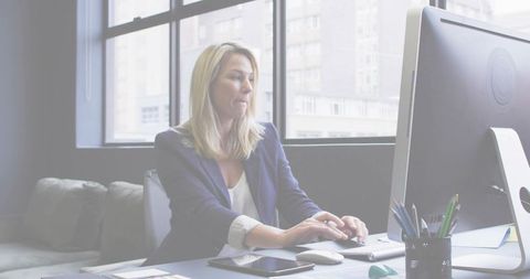 Woman professional analyzing color swatches at modern office workspace