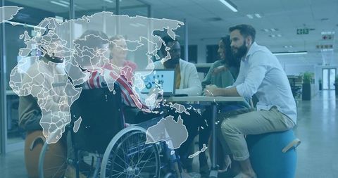 Diverse team collaborating in modern office with wheelchair accessibility