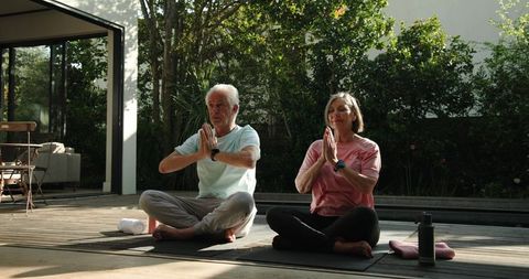 Senior Couple Practicing Meditation Outdoors at Modern Home