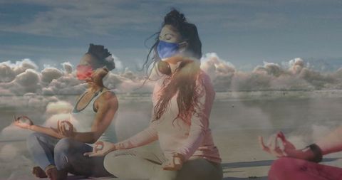 Women Meditating on Beach with Masks in Serene Atmosphere