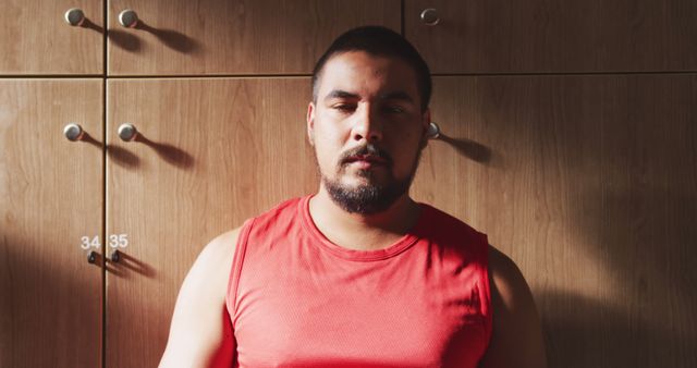 Man in Red Tank Top Relaxing Near Locker Cabinets - Download Free Stock Images Pikwizard.com