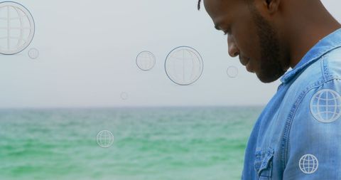 Digital Connections at the Beach: African American Man with Smartphone