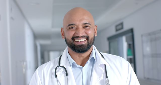 Confident Male Doctor Smiling in Hospital Corridor - Download Free Stock Images Pikwizard.com