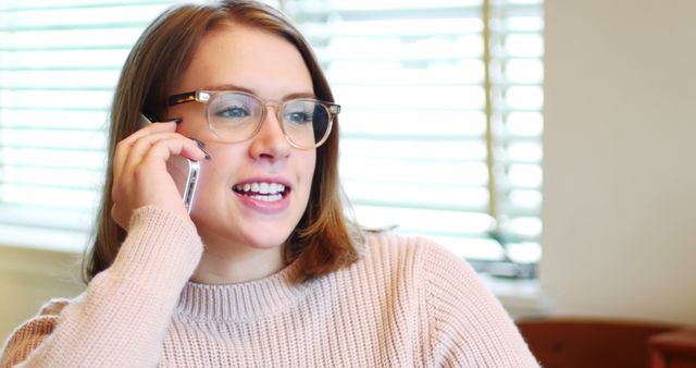 Smiling Woman in Sweater Talking on Smartphone - Download Free Stock Images Pikwizard.com