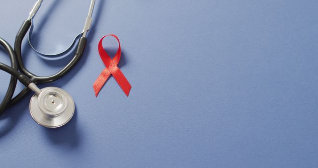 Image of stethoscope and red blood cancer ribbon on blue background - Download Free Stock Photos Pikwizard.com