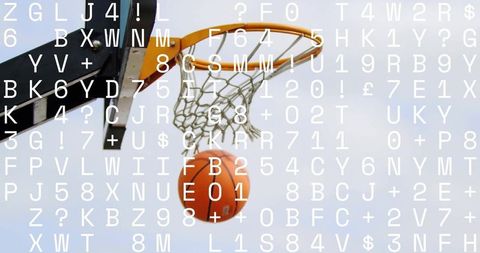 Basketball passing through hoop in a dramatic moment