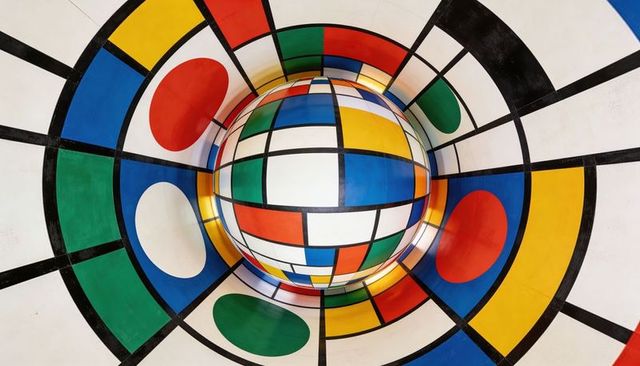 Colorful Geometric Sphere Creating Optical Illusion with Concentric Grid and Bold Shapes