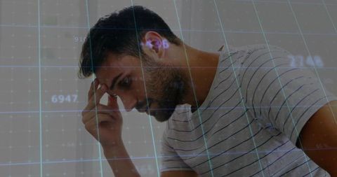 Bearded Man Analyzing Digital Data Overlays in Office Environment