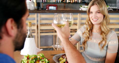 Young Couple Toasting with Wine at Restaurant - Download Free Stock Images Pikwizard.com
