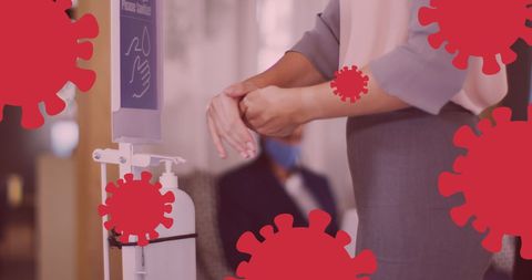 Caucasian woman using hand sanitizer during covid-19 pandemic with virus icons