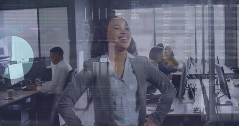 Confident businesswoman smiling amidst data analysis in modern office